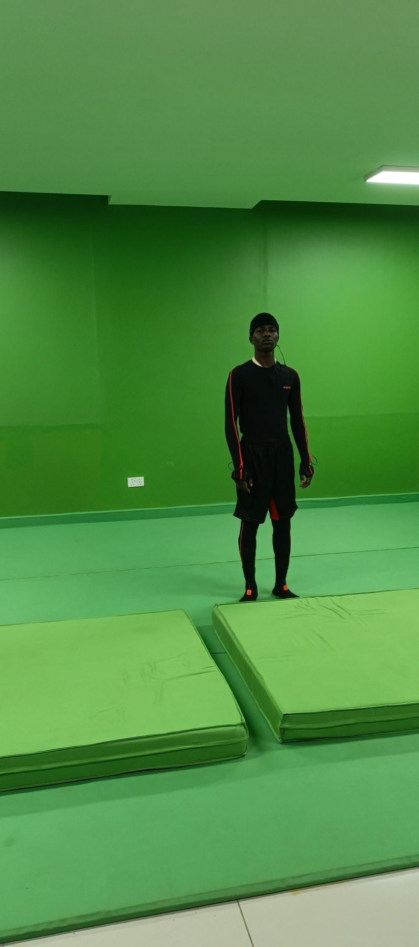 A performer on a green-screen stage