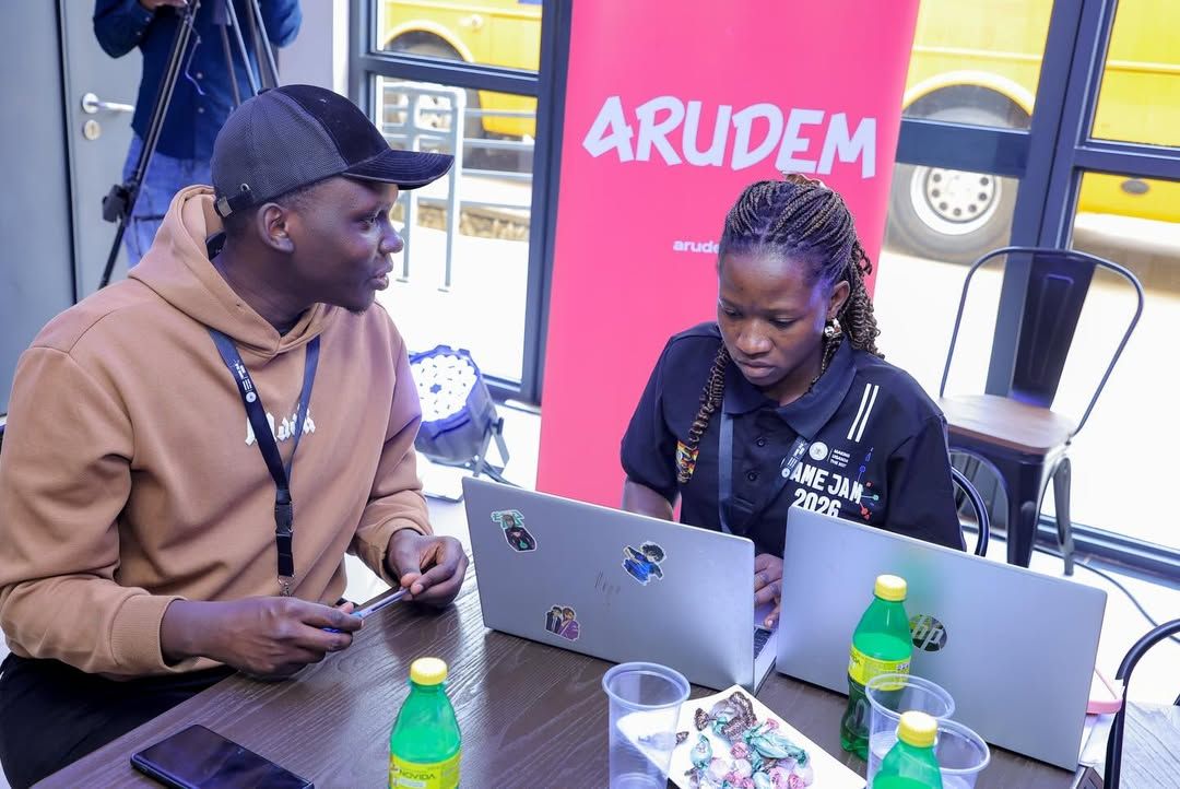 A mentor and participant talking at Game Jam 2026